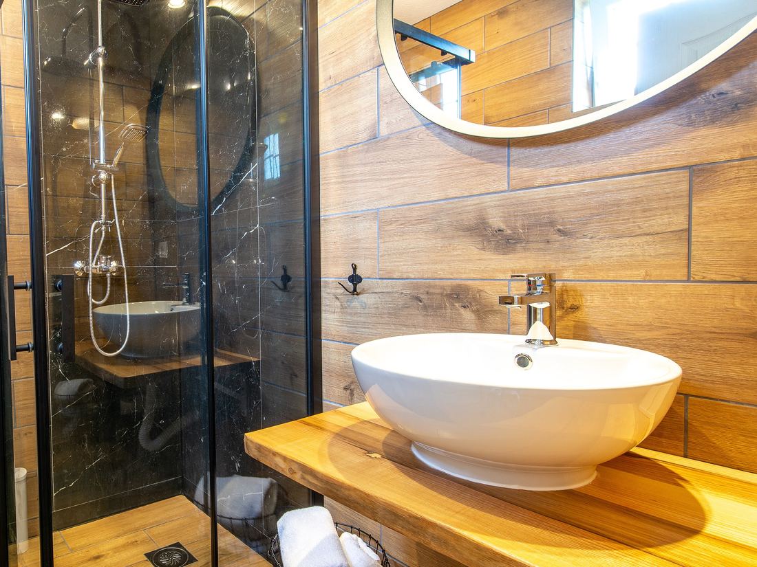 A modern bathroom with a glass shower enclosure